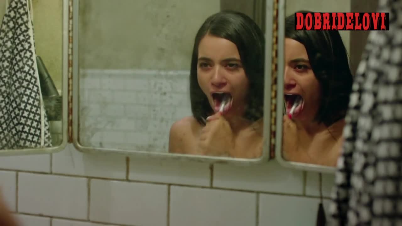 Paulina Gaitan brushes teeth topless in front of mirror