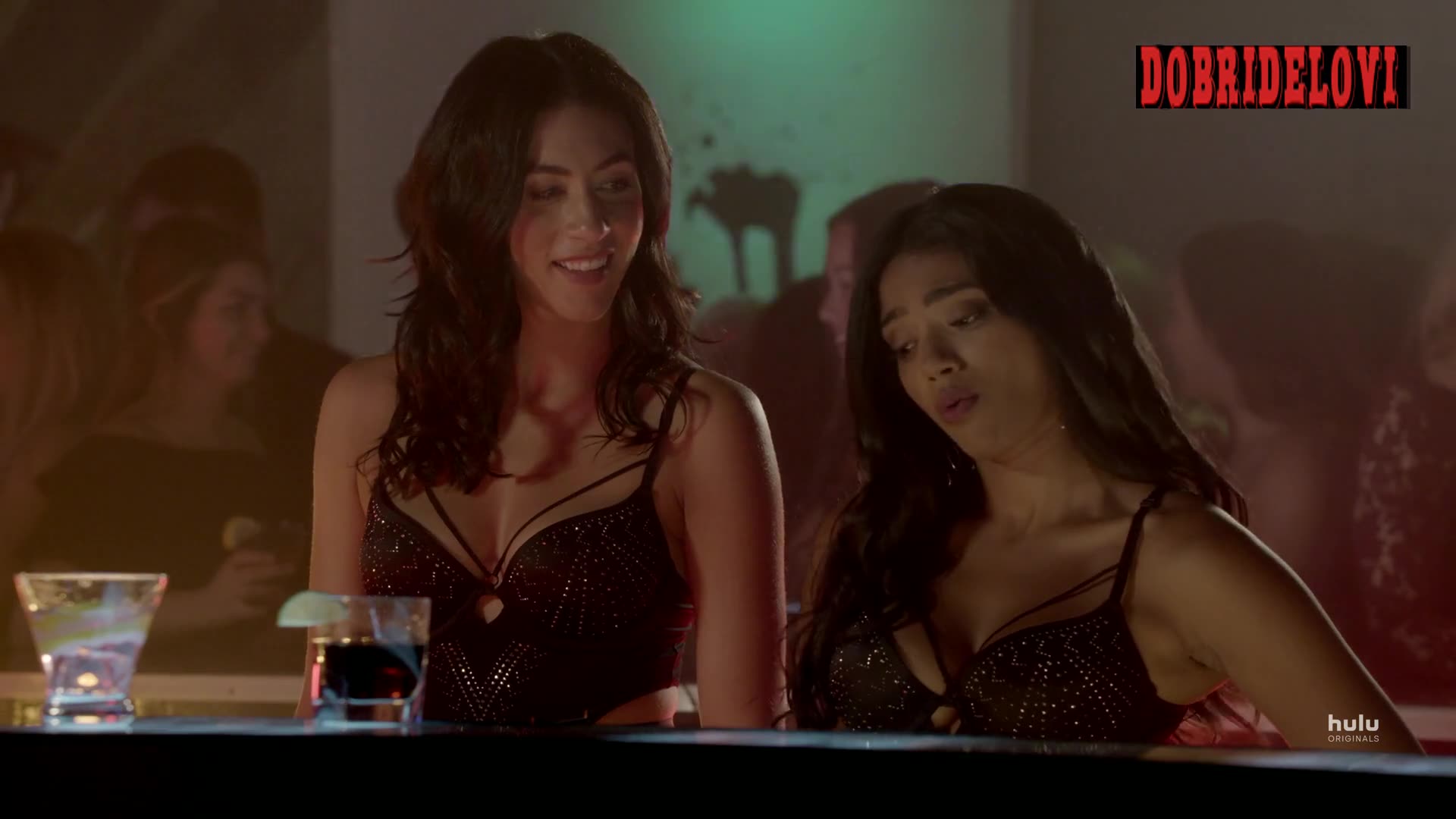 Nadine Bhabha and Sash Striga sexy cleavage scene in bar