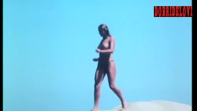 Gloria Guida running topless in the beach scene from Peccati di gioventù