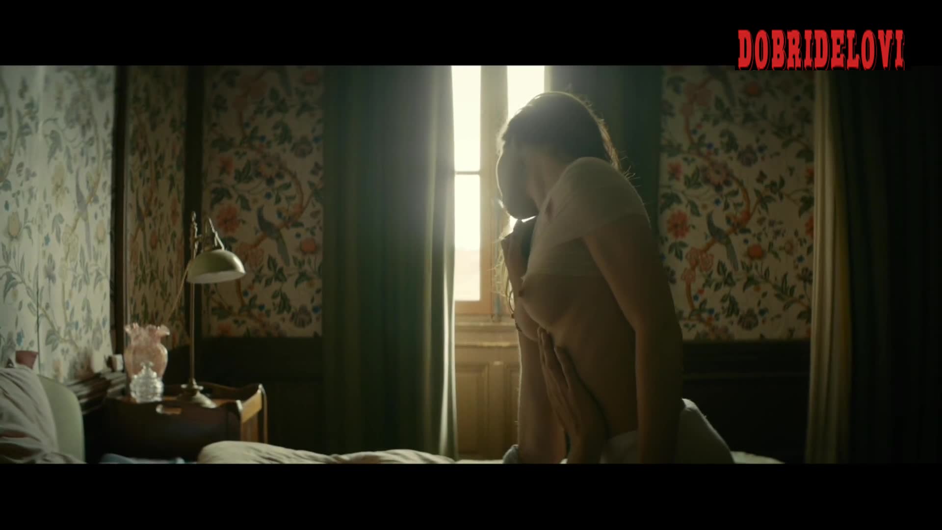 Esther Comar lays topless in bed -- House of Time