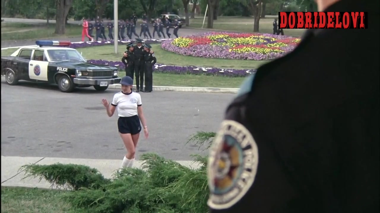 Kim Cattrall posing in cop shorts scene from Police Academy